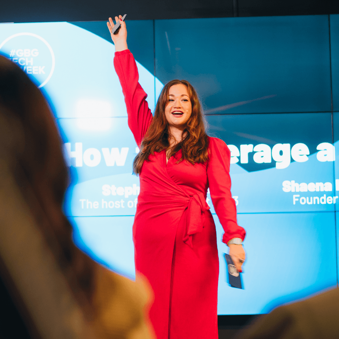 Stephanie presenting in a red suit
