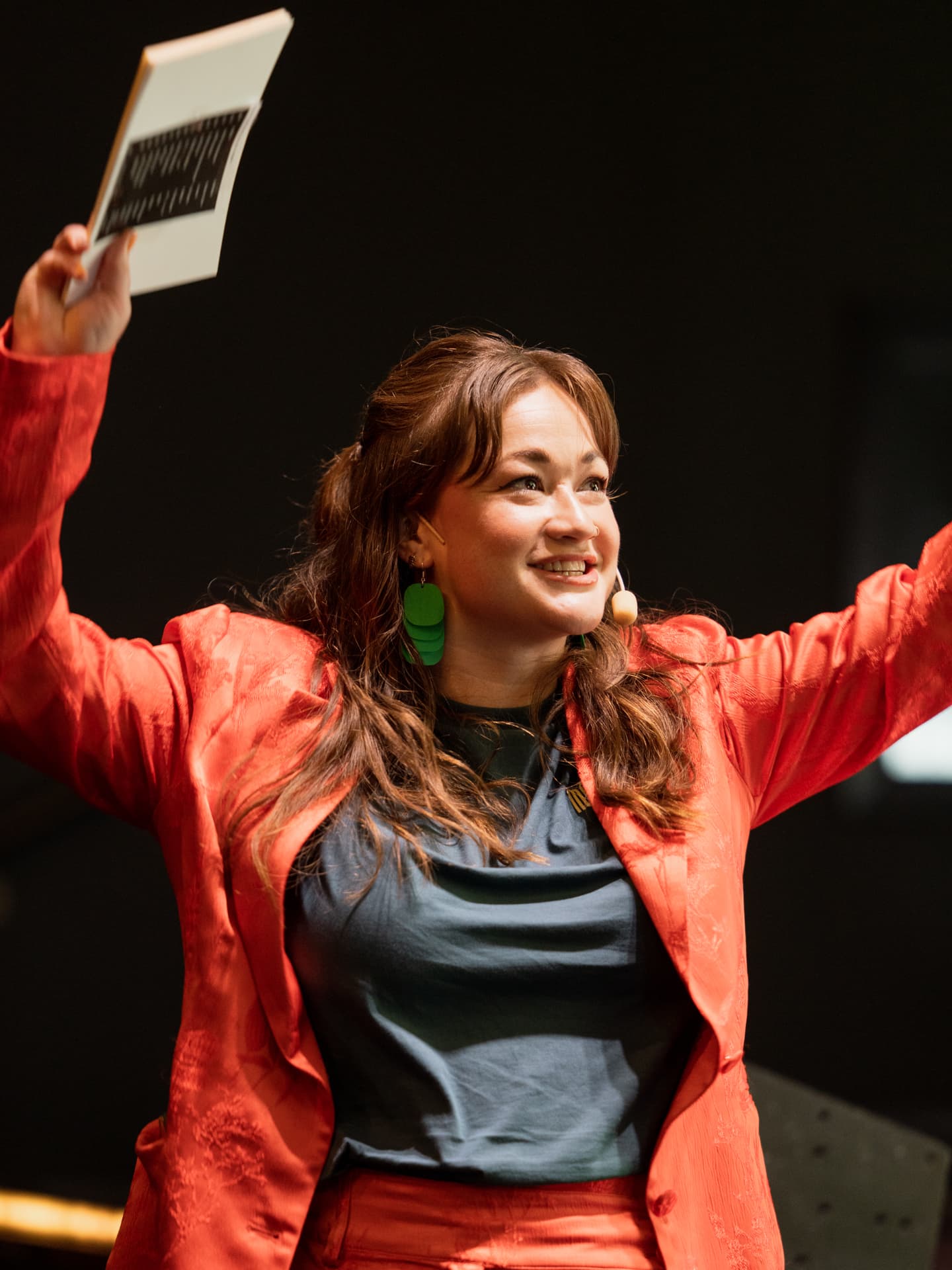 Stephanie speaking with energy on stage